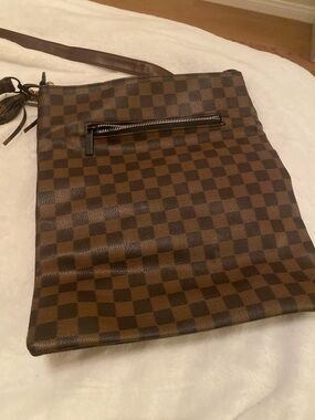 Brown Checkerboard Crossbody Bag has a slight slice on it